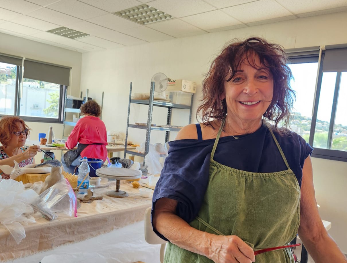 Lauren Kearns in a green apron in the studio