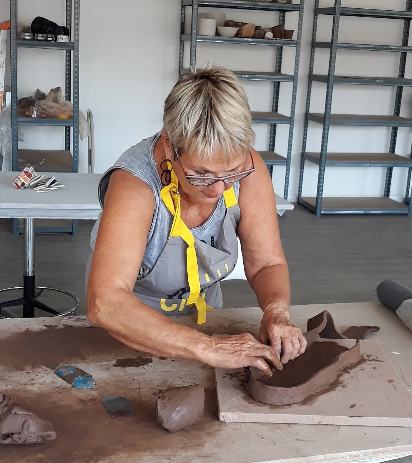 Instructor shaping a clay piece by hand
